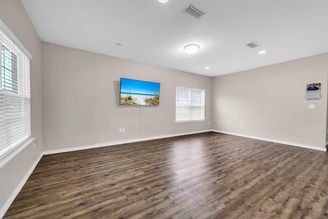 unfurnished room with dark hardwood / wood-style flooring