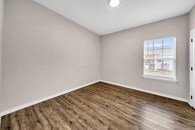 empty room featuring dark wood-type flooring