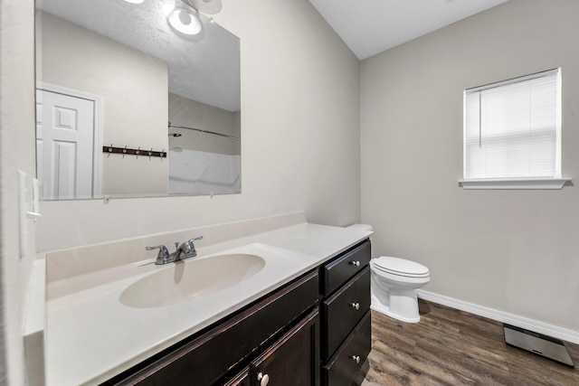 bathroom featuring vanity, toilet, wood-type flooring, and walk in shower