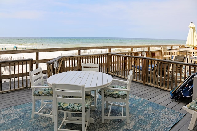 deck with a view of the beach and a water view