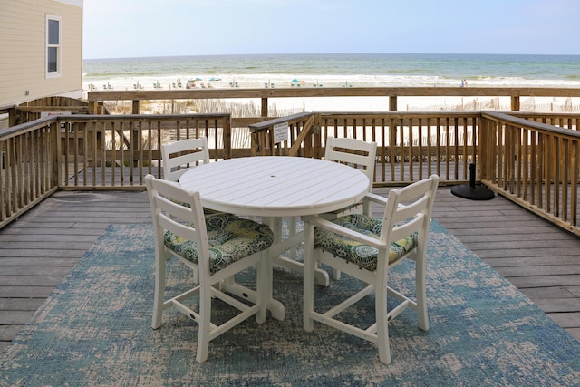 deck with a water view and a beach view