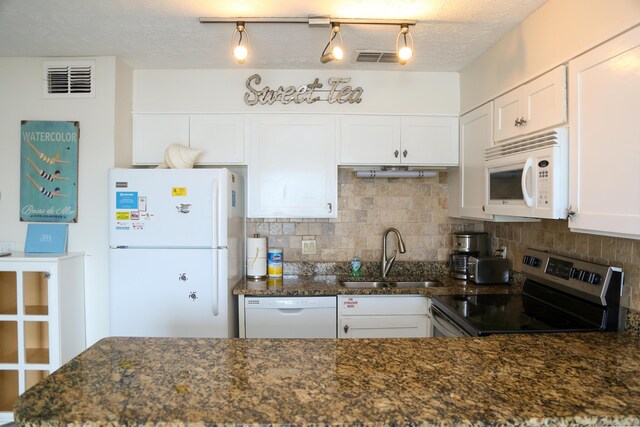 627 Eastern Lake Rd Unit 1, Santa Rosa Beach, FL 32459 - kitchen featuring white appliances, a sink, backsplash, white cabinets, and dark stone countertops