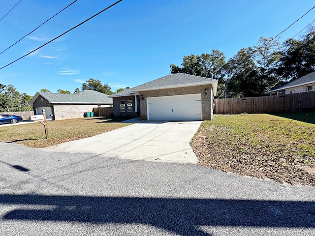 ranch-style home with a garage and a front lawn