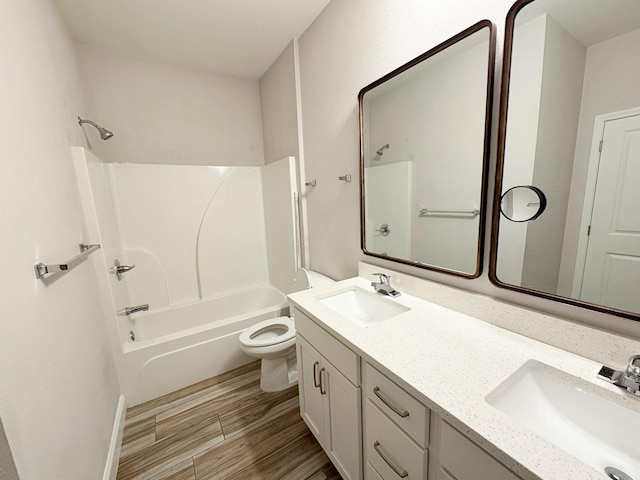 full bathroom featuring bathing tub / shower combination, vanity, and toilet