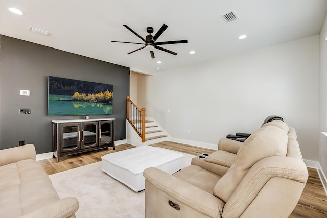 living room featuring hardwood / wood-style floors and ceiling fan