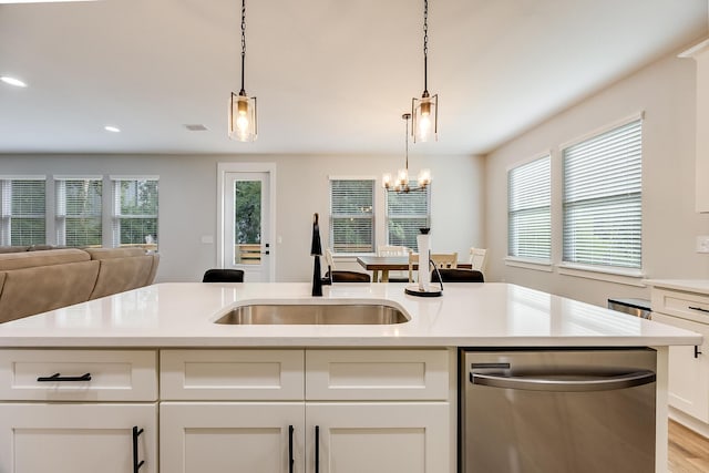 kitchen featuring a chandelier, sink, white cabinets, and stainless steel dishwasher