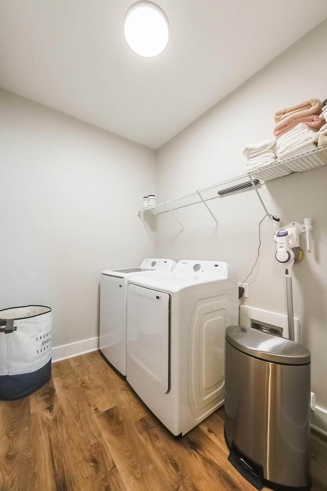 washroom featuring wood-type flooring and washing machine and dryer