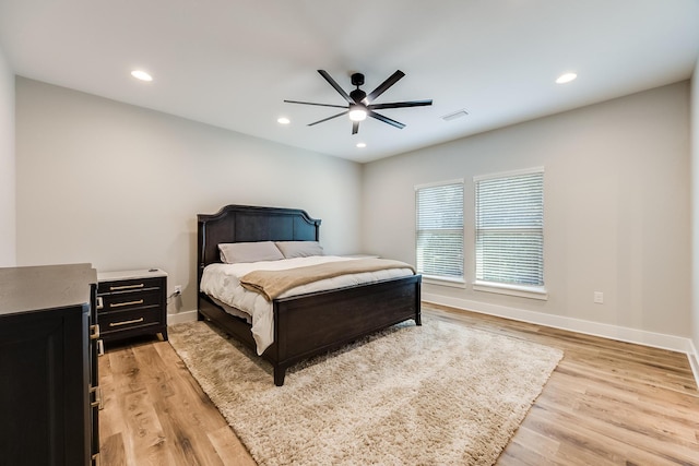 bedroom with ceiling fan and light hardwood / wood-style floors