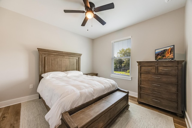 bedroom with ceiling fan and dark hardwood / wood-style flooring