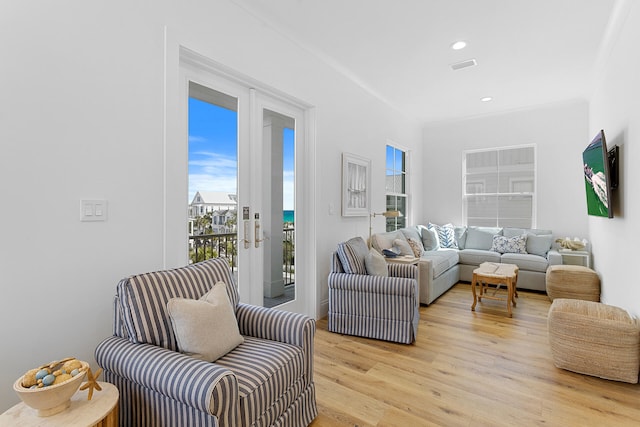 living room with french doors and light wood-type flooring