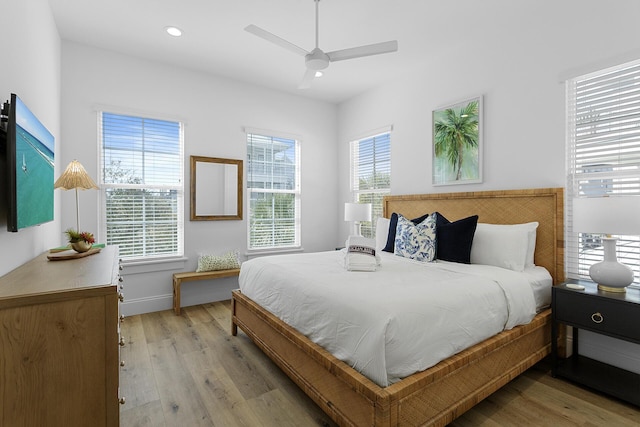 bedroom with ceiling fan and light wood-type flooring