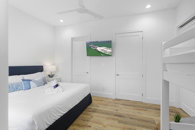 bedroom with ceiling fan and light wood-type flooring