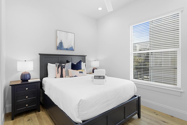 bedroom with ceiling fan and light wood-type flooring