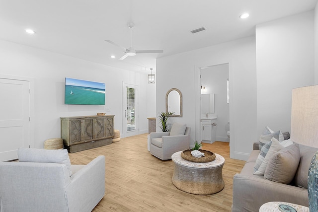 living room featuring hardwood / wood-style flooring and ceiling fan