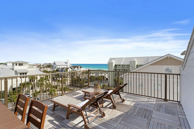 deck with a water view and a beach view