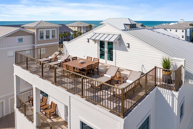 deck with french doors and a water view