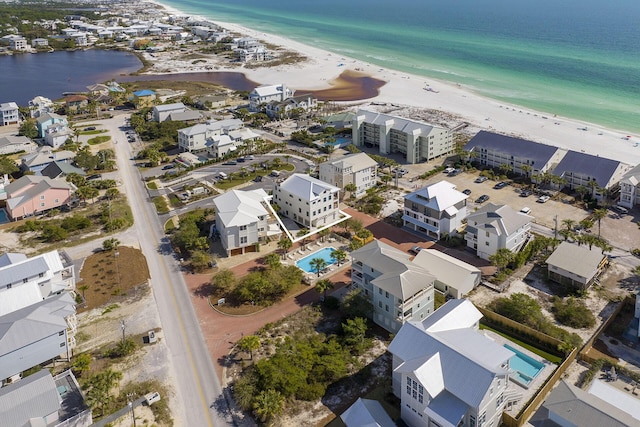 aerial view with a water view and a beach view