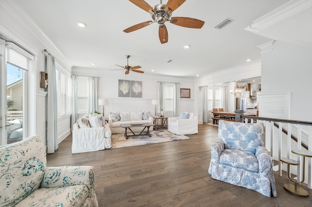 living room featuring dark hardwood / wood-style floors, ceiling fan, and ornamental molding