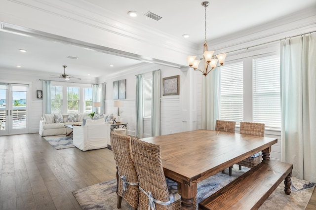 dining space with ceiling fan with notable chandelier, hardwood / wood-style flooring, and crown molding