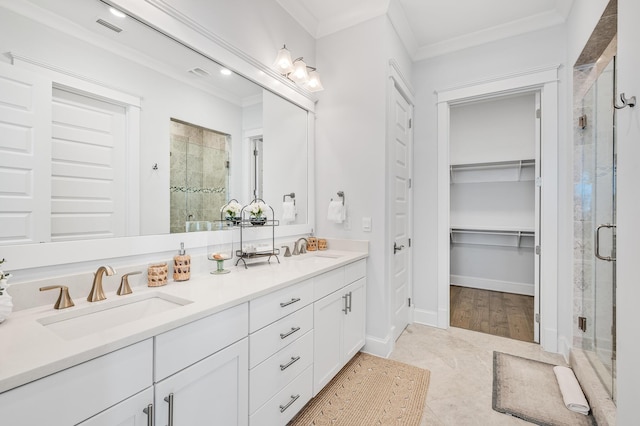 bathroom with vanity, an enclosed shower, and ornamental molding