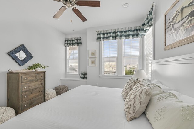 bedroom with multiple windows and ceiling fan