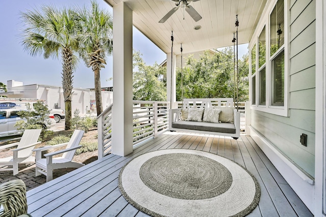 deck with ceiling fan and a porch