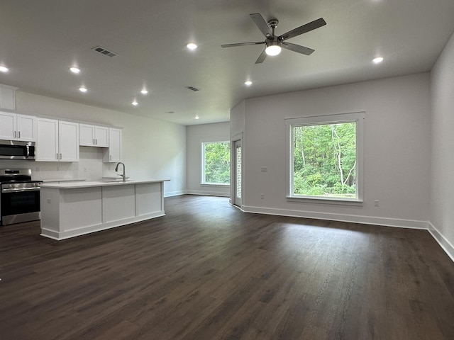 kitchen with recessed lighting, stainless steel appliances, dark wood-style floors, visible vents, and open floor plan