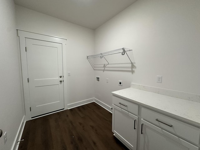 washroom featuring hookup for an electric dryer, dark wood-style flooring, cabinet space, hookup for a washing machine, and baseboards