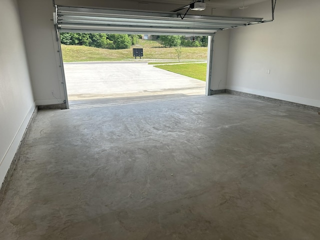 garage with a garage door opener and baseboards