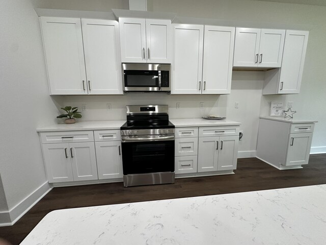 337 Shoal River Dr, Crestview, FL 32539 - kitchen with stainless steel appliances, dark wood-style floors, light countertops, and white cabinetry