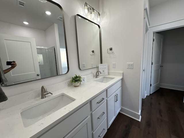 337 Shoal River Dr, Crestview, FL 32539 - bathroom with wood finished floors, double vanity, and an enclosed shower