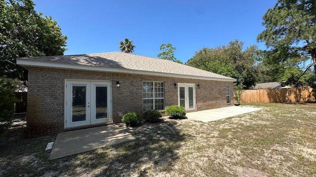 rear view of property featuring a patio, french doors, and a yard