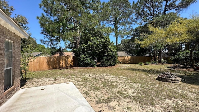 view of yard featuring a fire pit and a patio area