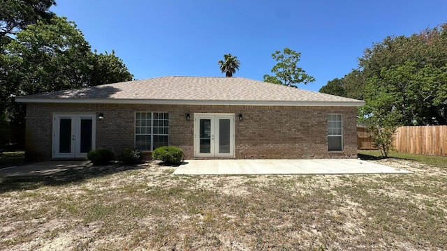 back of house with a patio, french doors, and a lawn