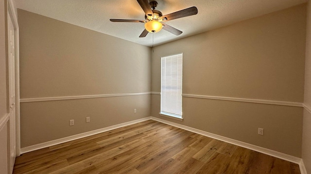 unfurnished room featuring ceiling fan and hardwood / wood-style flooring