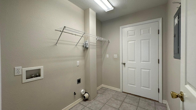 washroom with hookup for a washing machine, a textured ceiling, light tile patterned floors, and hookup for an electric dryer