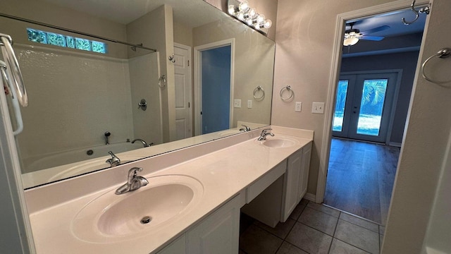 bathroom with french doors, ceiling fan, tile patterned floors, separate shower and tub, and vanity