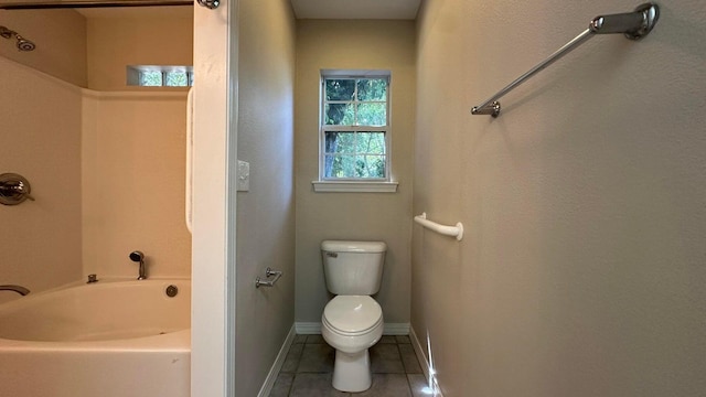 bathroom featuring toilet, tile patterned flooring, and a bathtub