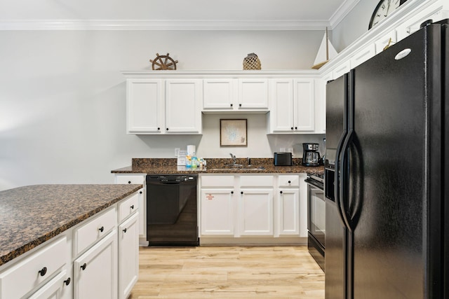 kitchen with dark stone counters, white cabinetry, black appliances, and ornamental molding