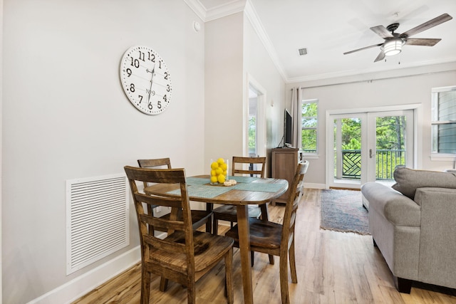 dining room featuring crown molding, french doors, ceiling fan, and light wood-type flooring