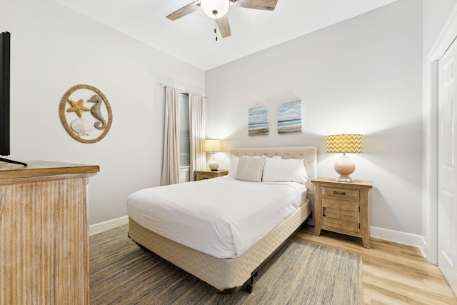 bedroom with wood-type flooring and ceiling fan