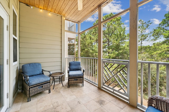 sunroom / solarium featuring plenty of natural light and wooden ceiling