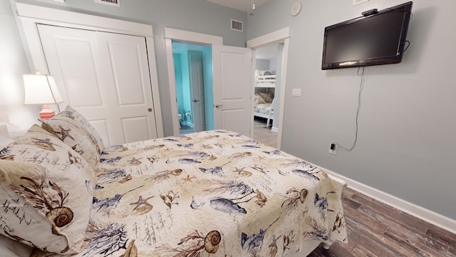 bedroom with a closet and dark hardwood / wood-style floors