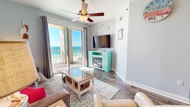 living room featuring hardwood / wood-style flooring and ceiling fan