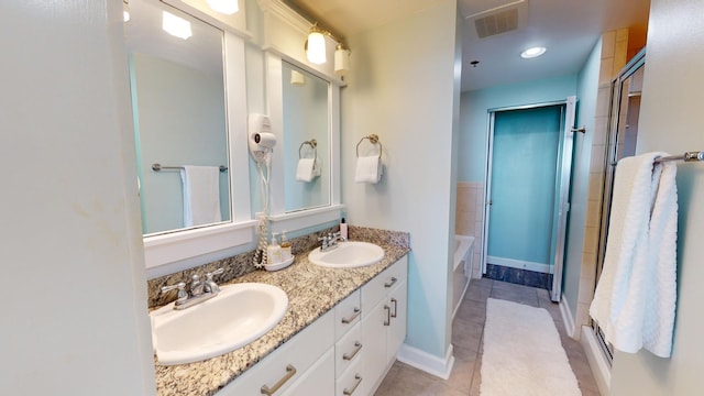 bathroom featuring tile patterned floors, vanity, and an enclosed shower