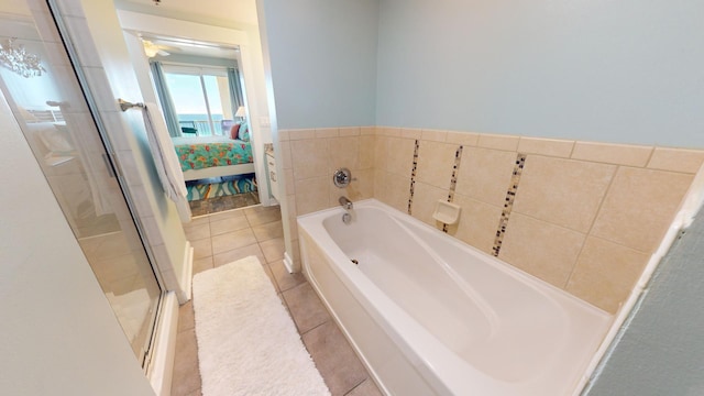 bathroom featuring tile patterned flooring and separate shower and tub