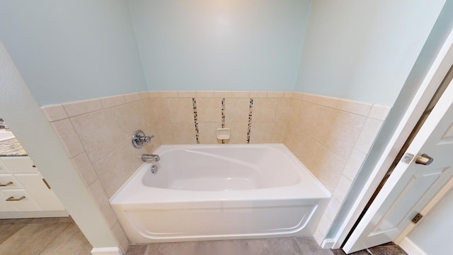 bathroom with a bathing tub and tile patterned flooring