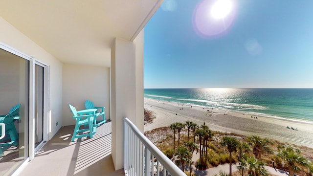 balcony with a beach view and a water view