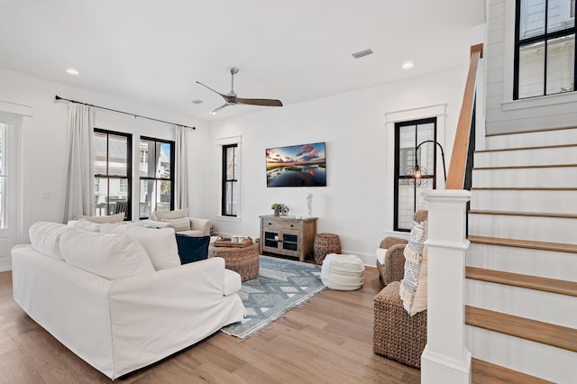 living room featuring ceiling fan and wood-type flooring