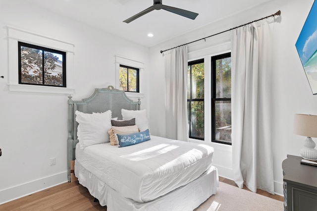 bedroom with ceiling fan and light hardwood / wood-style floors